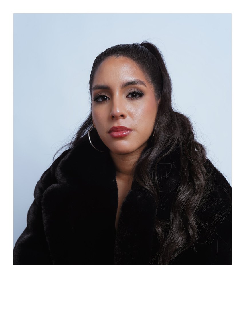 Close-up portrait of Marcela in a black fur coat