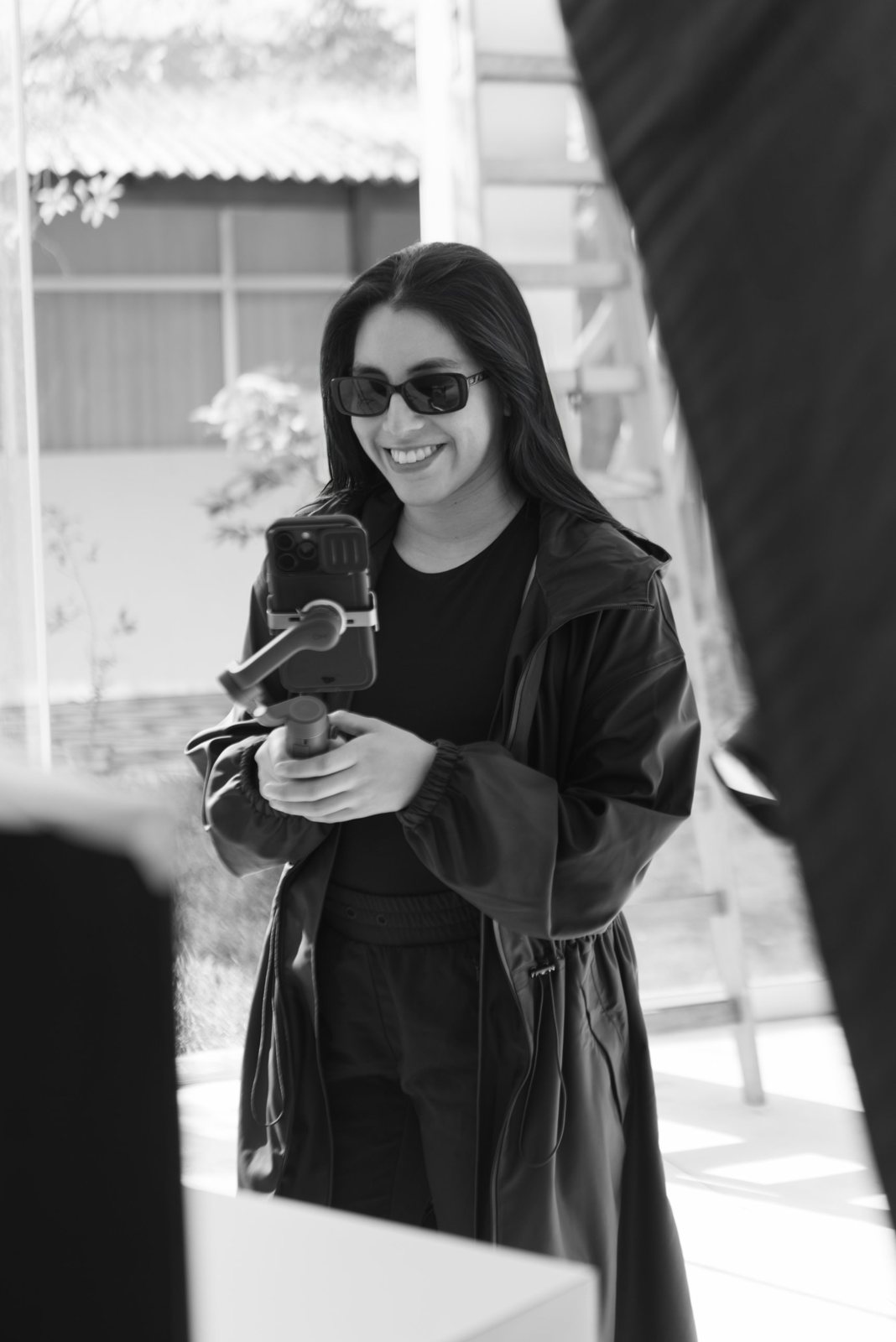 Marcela filming content with a phone gimbal on set